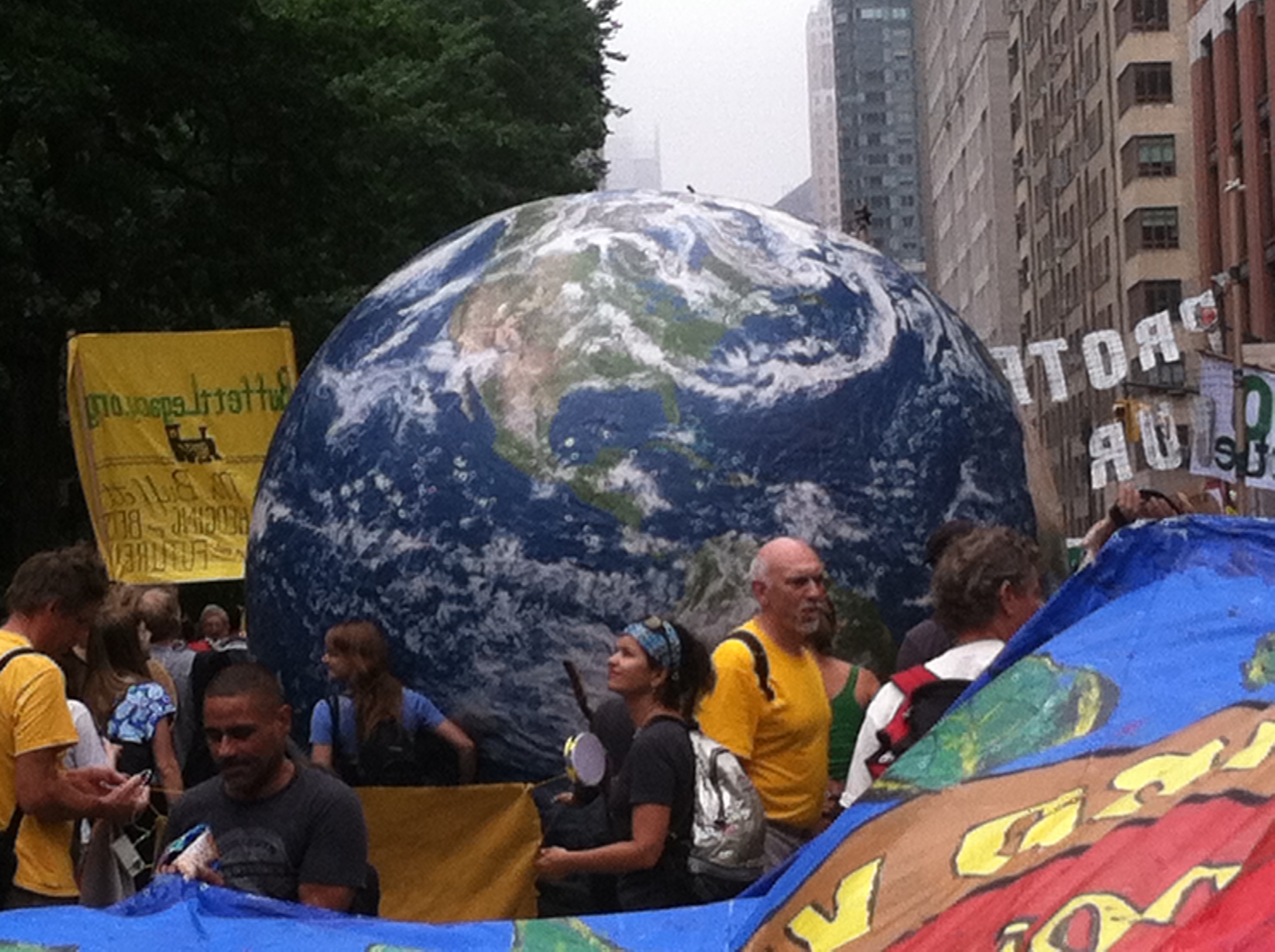 Large globe amidst marchers in 2016 NYC Climate March